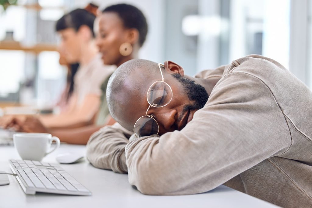 man at desk experiencing ozempic fatigue