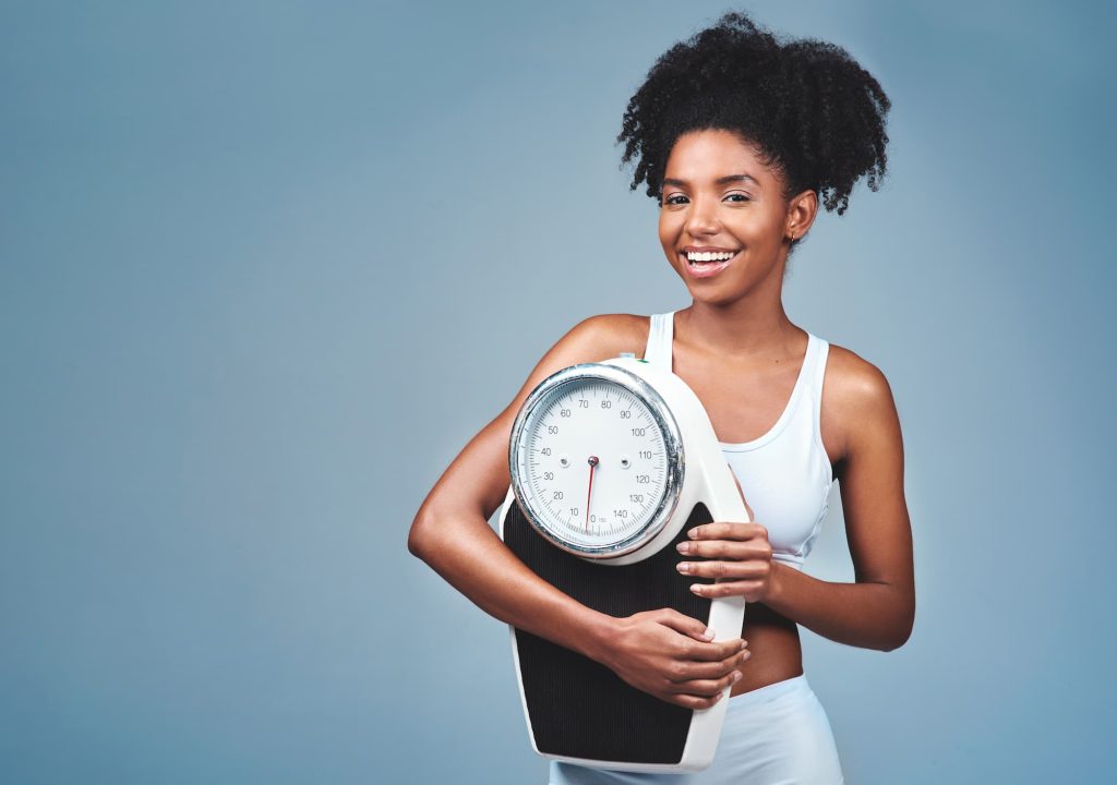 what does ozempic do for weight loss? woman holding a scale